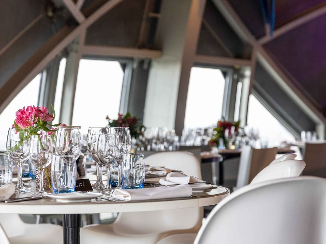 A long table set for dinner inside the Atomium sphere
